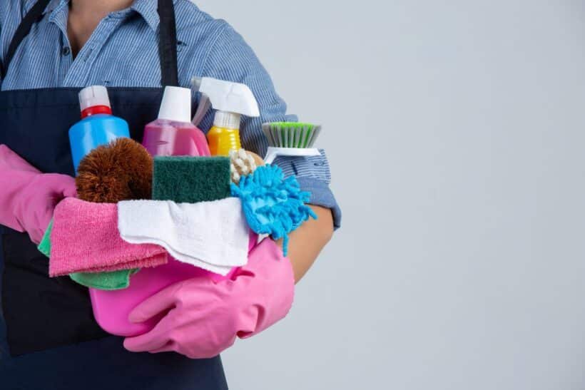 woman is holding cleaning product gloves rags basin white wall 1536x1024 1